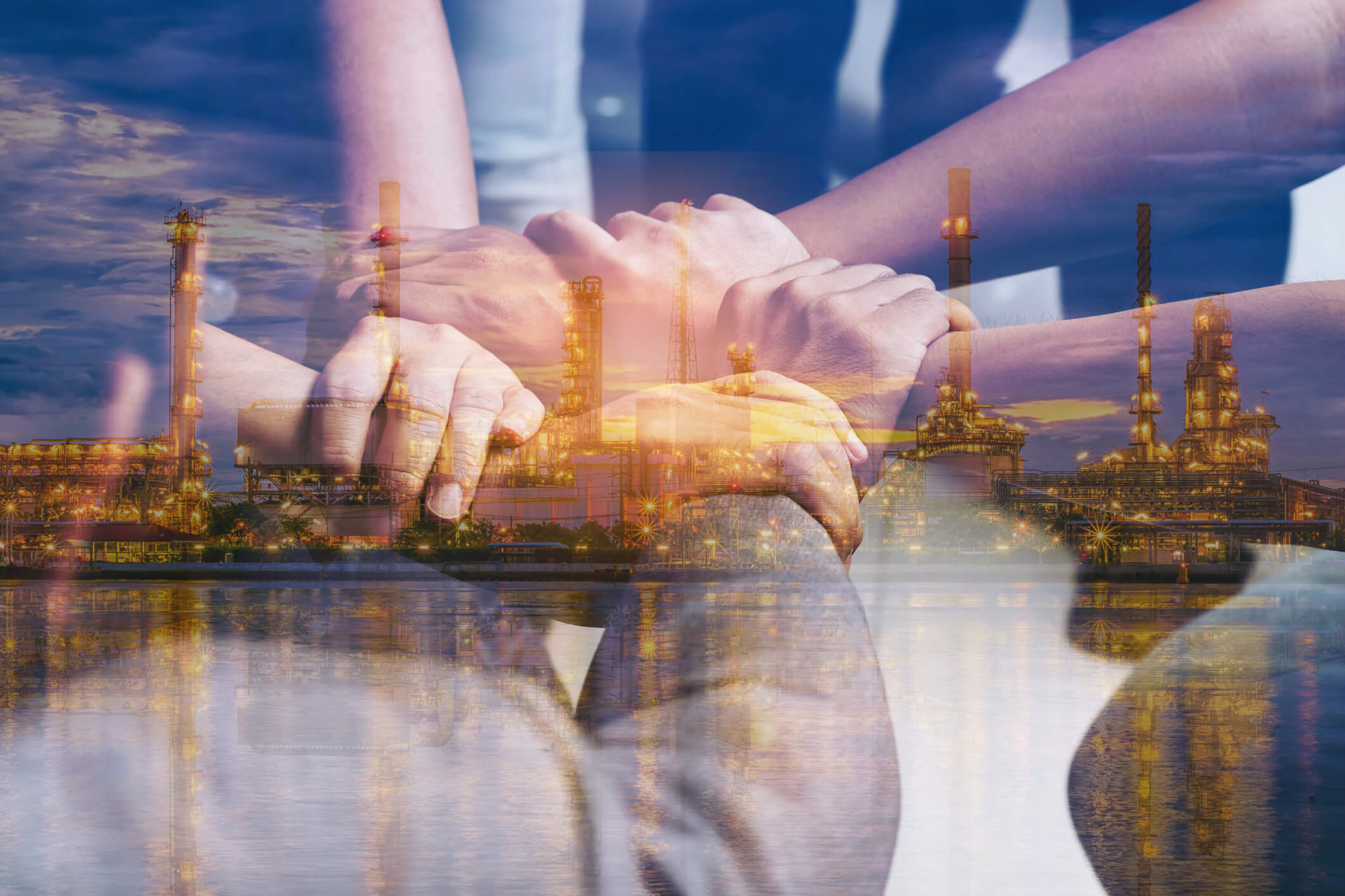 Double exposure of hands collaboration and oil refinery